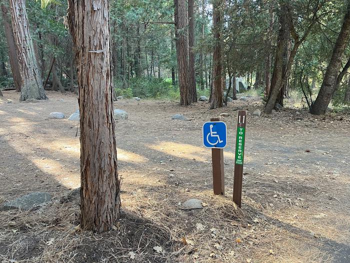 Scene showing full accessible campsite, parking pad and post with the number 11 on itADA Site #11 Parking Pad
