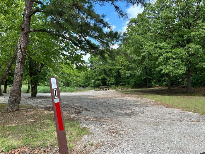 A photo of Site 1 of Loop  at Sunset Bay with Picnic Table, Fire Pit, Shade, Tent Pad, Waterfront, Lantern PoleSite 1 is located just below the entrance of the park immediately to the right down the hill.