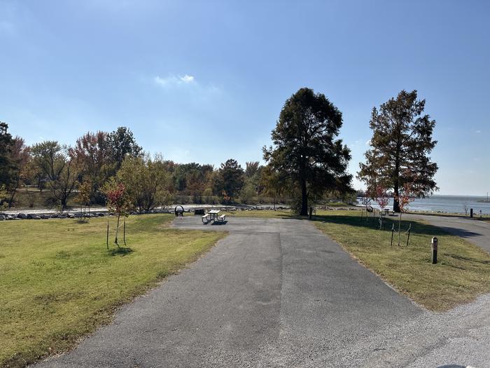 A photo of Site 028 of Loop L1 at Coles Creek Campground with Picnic Table, Electricity Hookup, Fire Pit