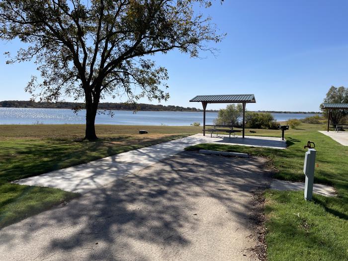 A photo of Site D11 of Loop D at LAKESIDE (OK) with Picnic Table, Electricity Hookup, Fire Pit, Shade, Waterfront, Water Hookup