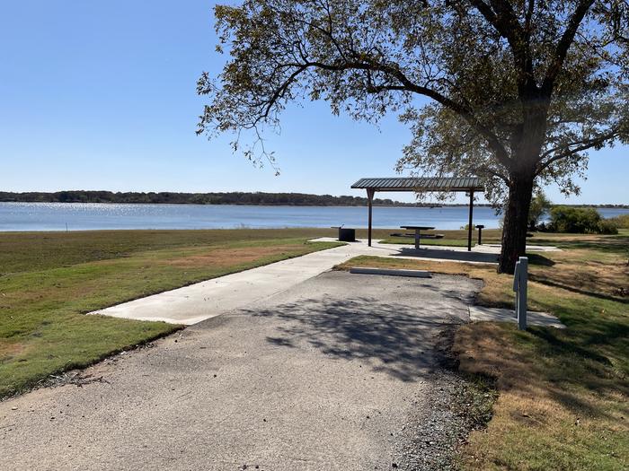 A photo of Site D13 of Loop D at LAKESIDE (OK) with Picnic Table, Electricity Hookup, Fire Pit, Shade, Waterfront, Water Hookup