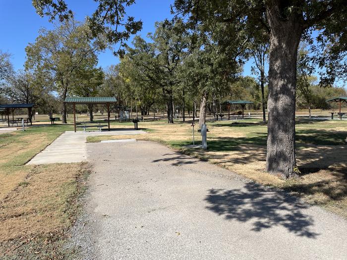 A photo of Site D16 of Loop D at LAKESIDE (OK) with Picnic Table, Electricity Hookup, Fire Pit, Shade, Water Hookup