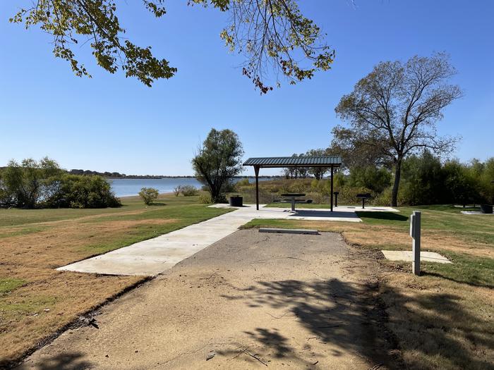 A photo of Site D07 of Loop D at LAKESIDE (OK) with Picnic Table, Electricity Hookup, Fire Pit, Shade, Waterfront, Water Hookup