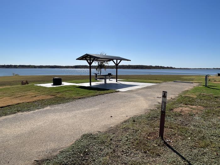 A photo of Site D15 of Loop D at LAKESIDE (OK) with Picnic Table, Electricity Hookup, Fire Pit, Waterfront, Water Hookup