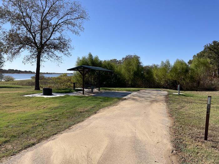 A photo of Site D05 of Loop D at LAKESIDE (OK) with Picnic Table, Electricity Hookup, Fire Pit, Shade, Waterfront, Water Hookup