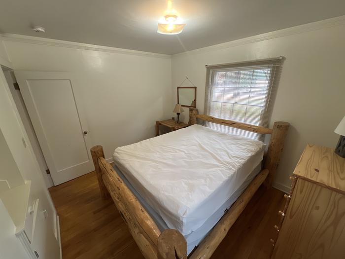 Savenac West Cottage bedroom with queen bed. 