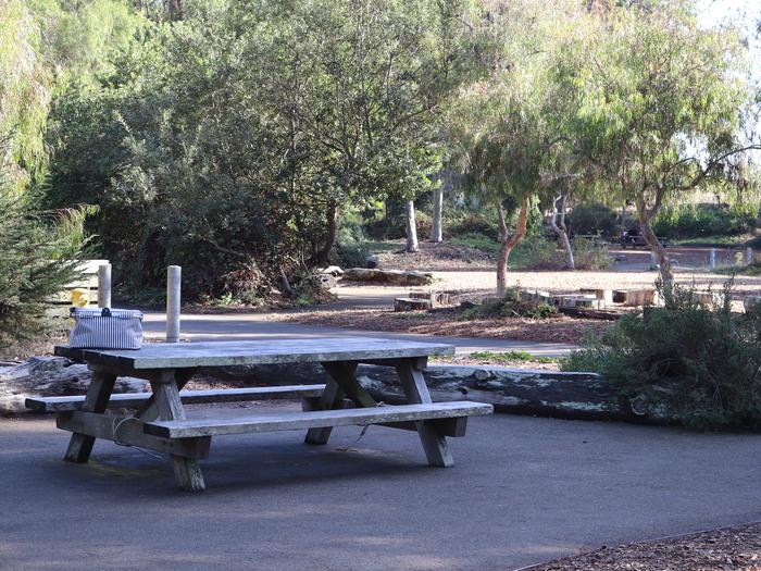 Rob Hill Day Use - Great for gatheringsA picnic table with a baskets looks to the rest of the camp ground 