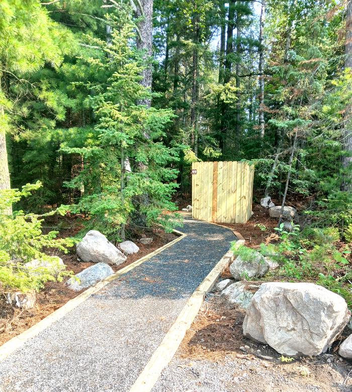 R104 - Saginaw Bay West, privacy guard for privy at campsite.Accessible trail leading to privy with privacy screen.