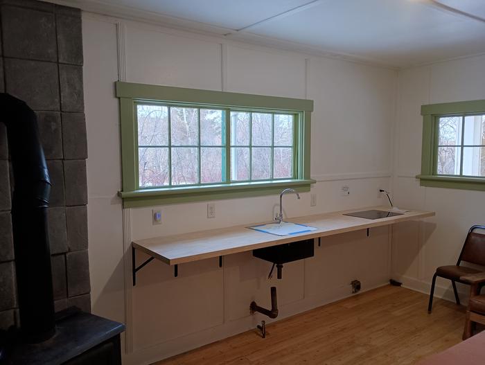 Dining Area and Kitchen SinkCabin rental includes an electric stovetop, cooking prep area and dining table. 