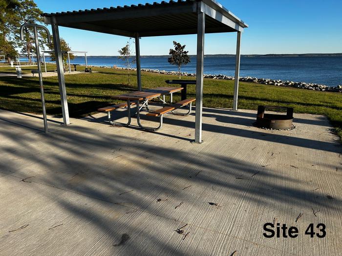 Amenities include; power pedestal 50/30/30 amp, water hookup, shelter, lantern post, picnic table, grill stand, fire ring with grill, level concrete pad.