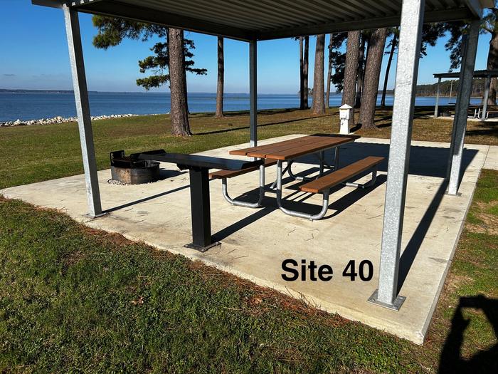 Amenities include; power pedestal 50/30/30 amp, water hookup, shelter, lantern post, picnic table, grill stand, fire ring with grill, level concrete pad.