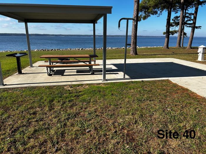 Amenities include; power pedestal 50/30/30 amp, water hookup, shelter, lantern post, picnic table, grill stand, fire ring with grill, level concrete pad.