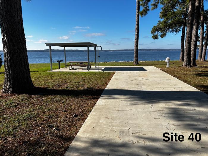 Amenities include; power pedestal 50/30/30 amp, water hookup, shelter, lantern post, picnic table, grill stand, fire ring with grill, level concrete pad.