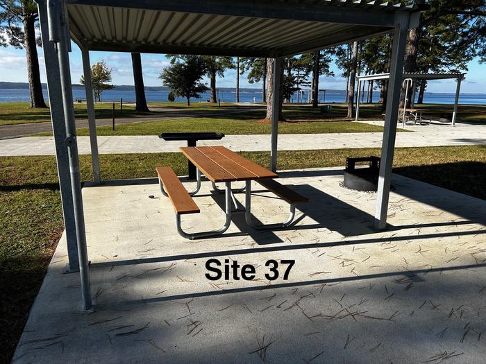 Amenities include; power pedestal 50/30/30 amp, water hookup, shelter, lantern post, picnic table, grill stand, fire ring with grill, level concrete pad.