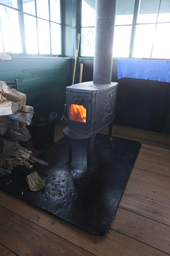 Big Hole Lookout inside 3Wood stove with fire