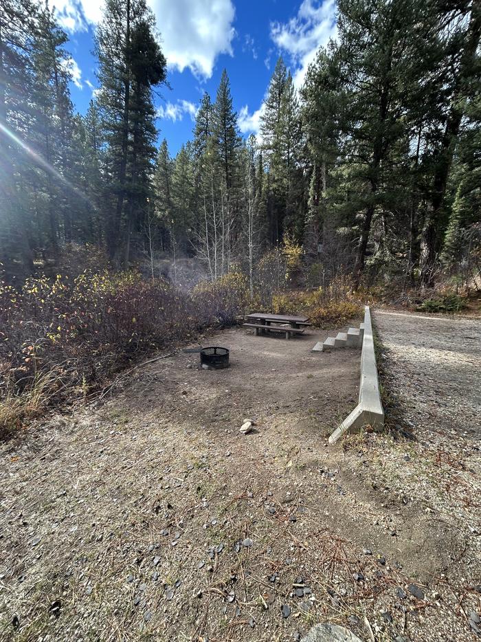 Stairs from parking spot lead to campsite with fire ring and picnic tableStairs lead from parking spot to campsite