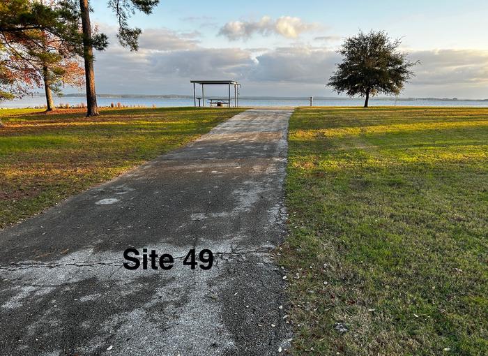 Amenities include; power pedestal 50/30/30 amp, water hookup, shelter, lantern post, picnic table, grill stand, fire ring with grill, level concrete pad.