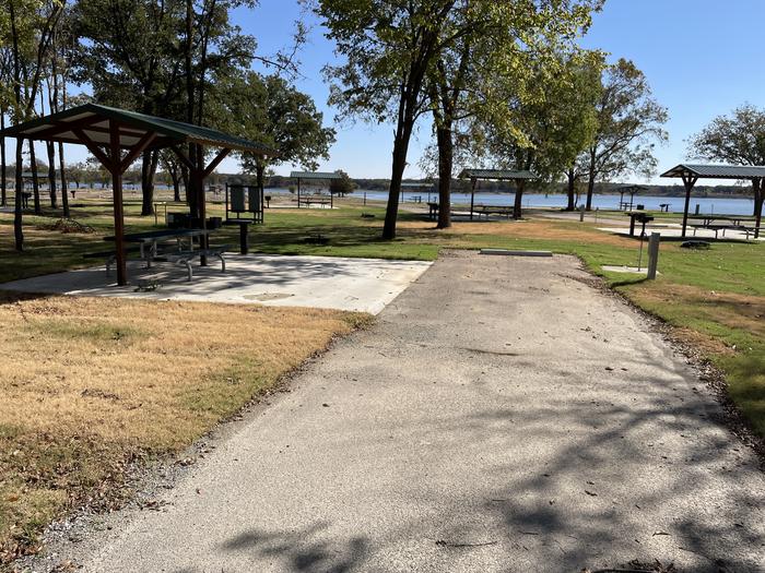 A photo of Site D23 of Loop D at LAKESIDE (OK) with Picnic Table, Electricity Hookup, Fire Pit, Shade, Water Hookup