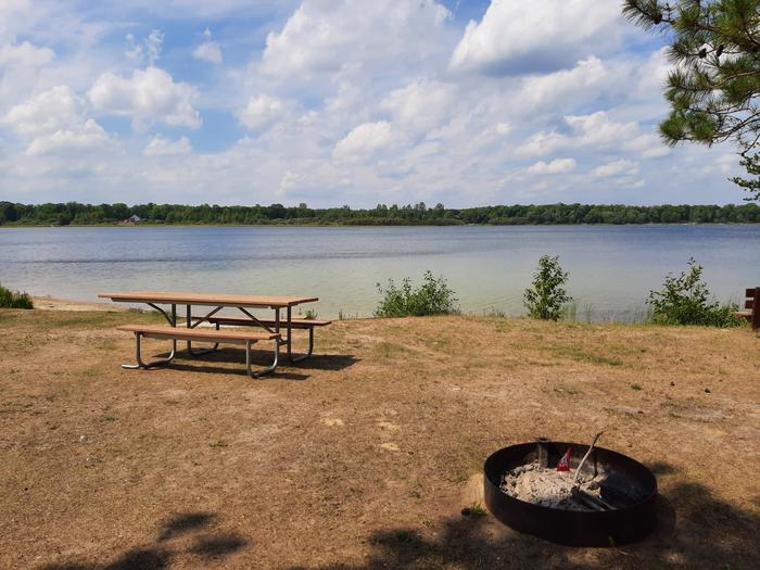 A picture of Mabel Lake with a firering and picnic table.Mabel Lake Picnic Area