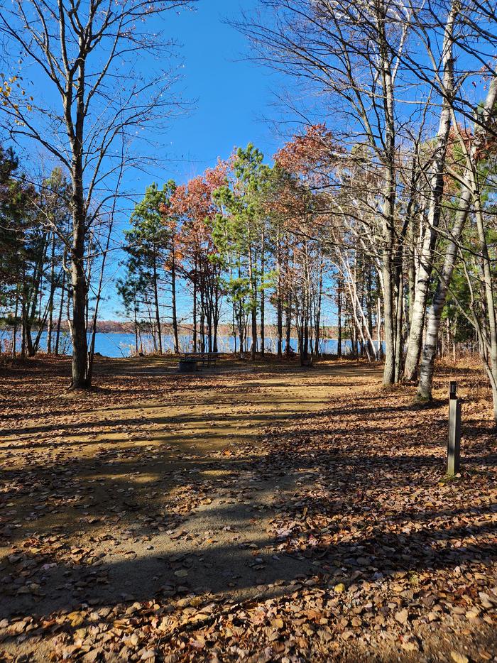 A picture of a campsite in Mabel Lake Campground with a site marker and trees.A campsite at Mabel Lake Campground.