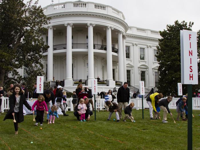 Kids rolling eggs in front of the White House at the Easter Egg Roll EventKids rolling eggs at the White House Easter Egg Roll