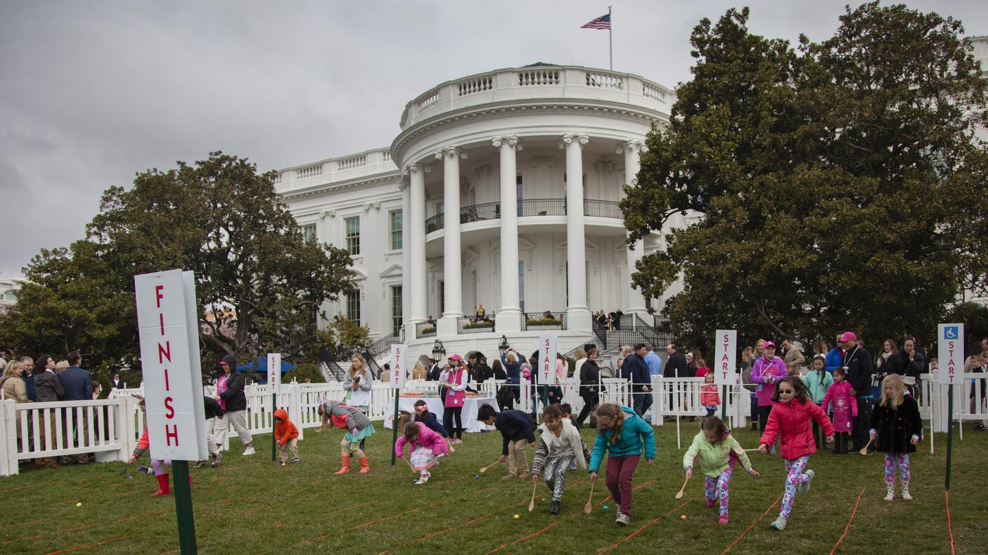 Kids rolling eggs in front of the White House at the Easter Egg Roll EventKids rolling eggs at the White House Easter Egg Roll