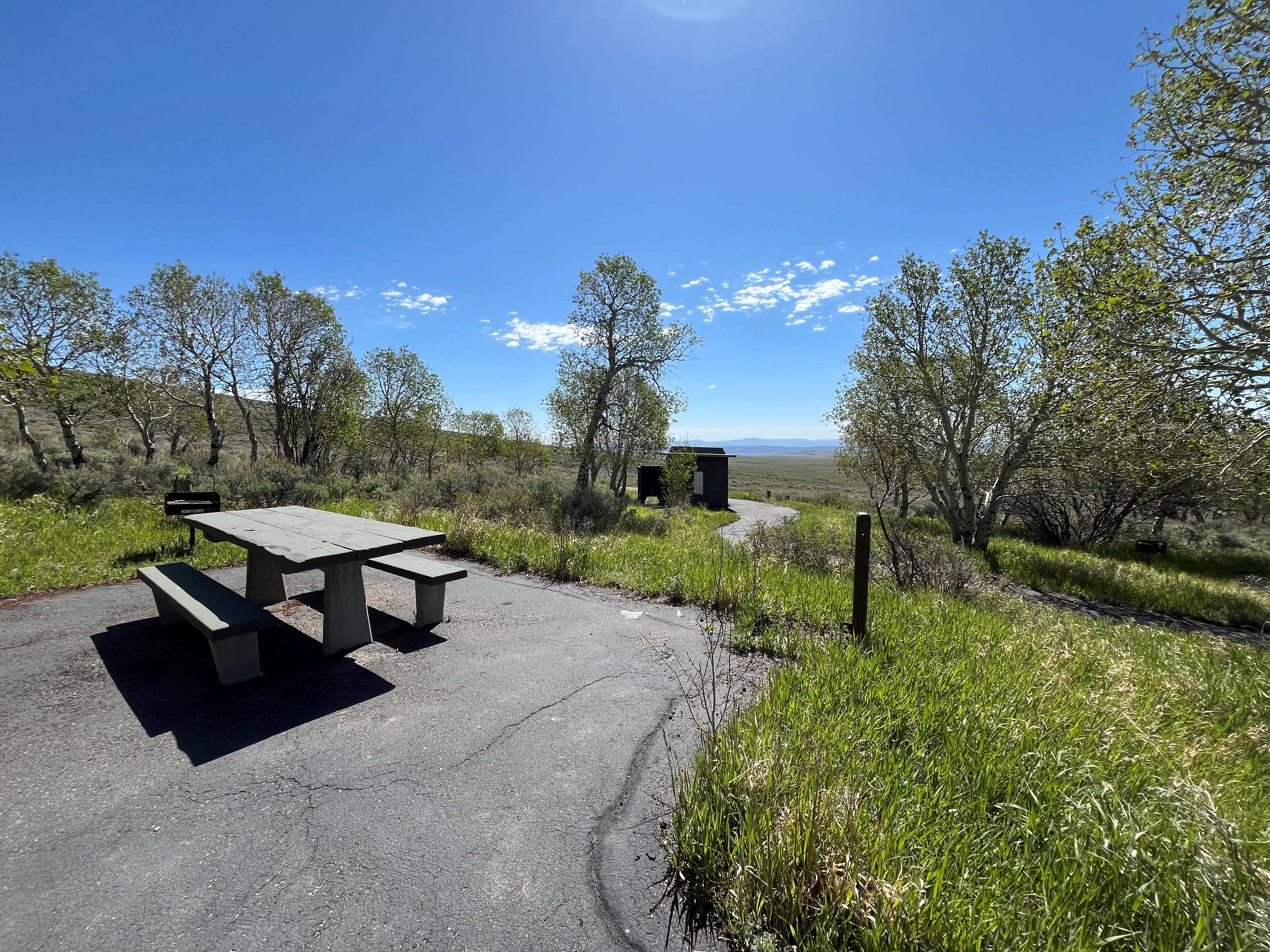 Picnic area with vault toilet in background