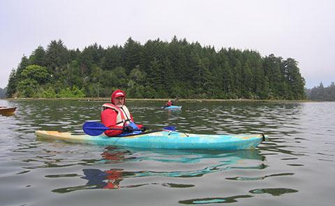 Kayaker paddling in South Slough National Estuarine Research Reserve, Oregon