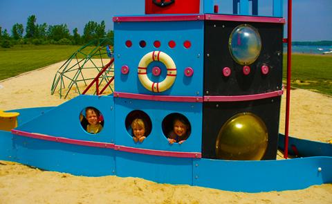 Kids playing in a wooden ship on a playgroundKids on playground