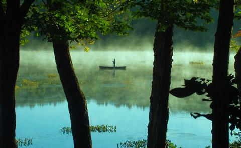 canoe on a foggy lakepaddling the lake