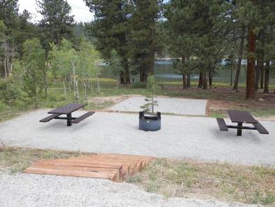 Campsite near lake with two picnic tables and a fire pitCampsite with two picnic tables and a fire pit