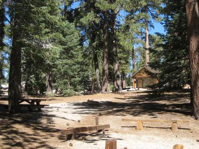Campsite with picnic table and restroom.