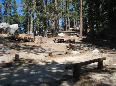 Campsite with picnic table and parking area.