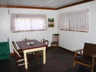 Room with windows, tables, and chairs located in the middleDining area