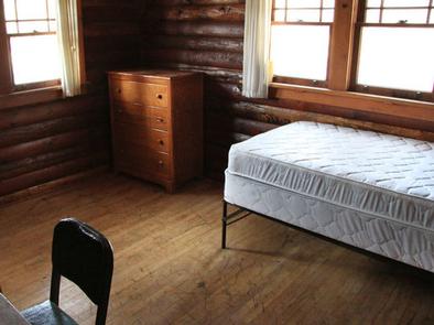 single bed, chest of drawers inside cabin