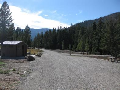 Red Cliff Campground road, vault toilet, picnic table & pine treesRed Cliff Campground