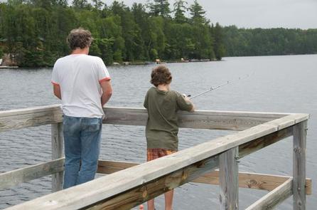 Picture of people fishing from the fishing pier.Fenske Lake fishing pier, with people fishing.