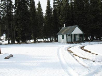 Snowy landscape with Buck Park Cabin in the background.Early winter at Buck Park Cabin