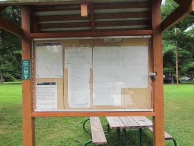 Campground rules and information kiosk next to parking lotInformation kiosk - check here for rules and alerts