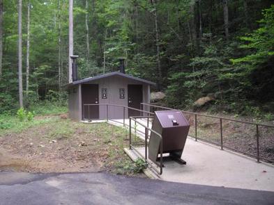 Rock Creek Campground (TN)Brown bear-proof garbage can on paved walkway to newly installed vault toilet.