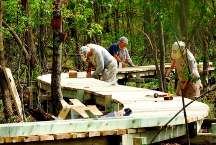 Volunteers build a boardwalk at Straight Lake State Park