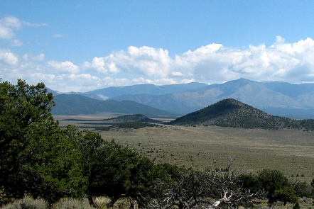 Rio Grande del Norte National MonumentDistant view of a large open area with tall mountains in the background.