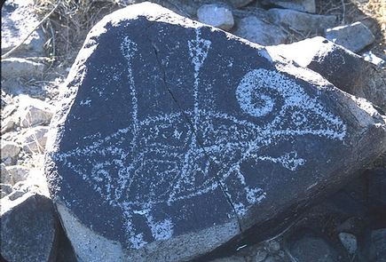 A petroglyph at Three Rivers Petroglyphs SiteA petroglyph of a horned animal with two arrows in its back.